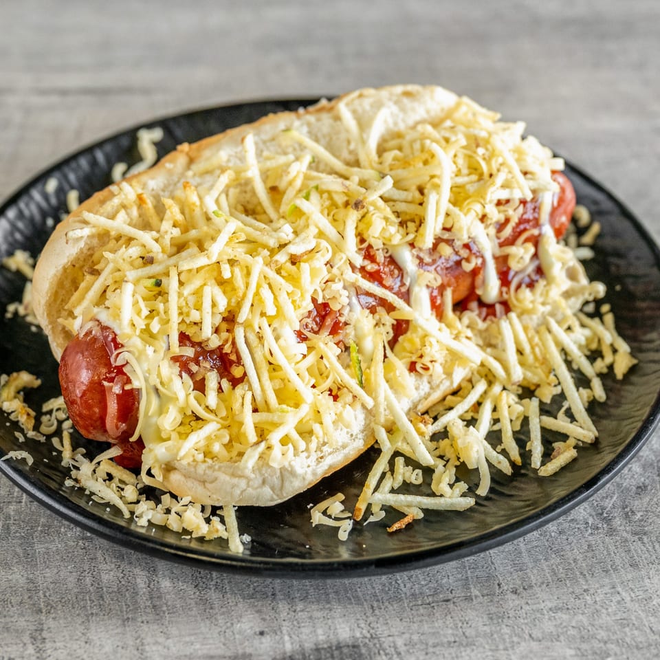 Venezuelan hot dog from Calle El Hambre, topped with ketchup, mayonnaise, and crispy potato sticks.